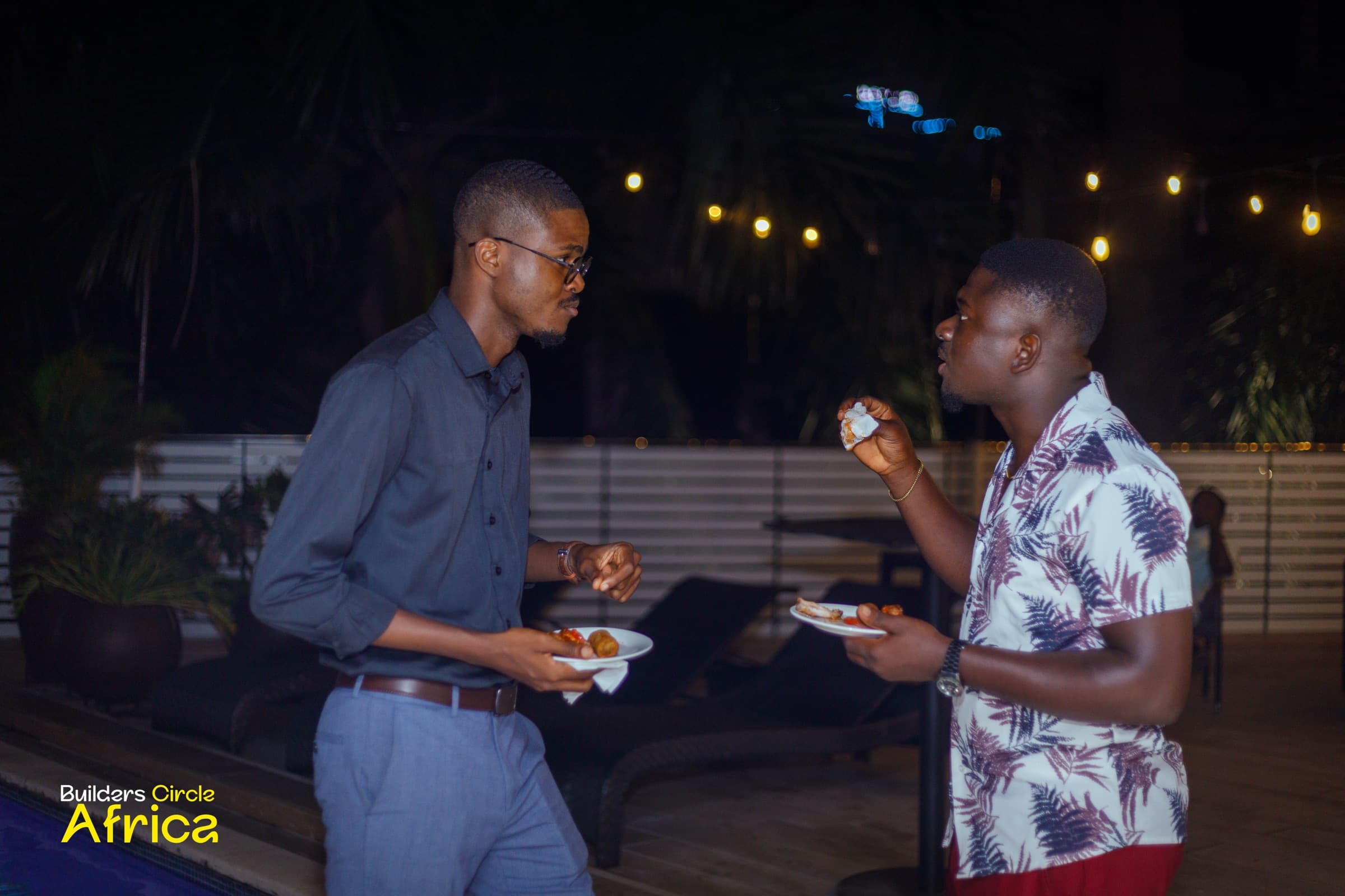 Two guests chatting poolside